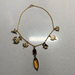 Bag charm gold w/animal & an amber stone accents.NWOT
